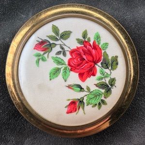 Vintage makeup compact with roses on front